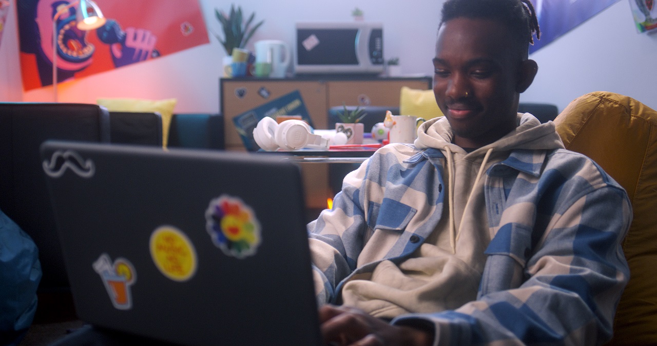 Young adult male using laptop