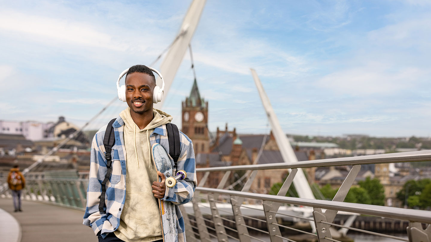 Young man smiling on peace brige in Derry Londonderry