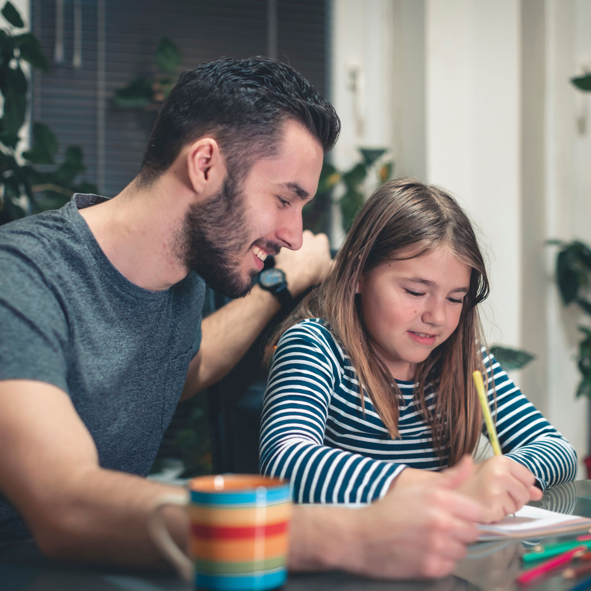 Male bank staff helping young girl with Money smart learning