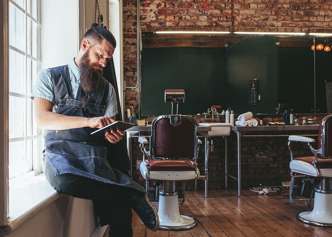Male barber using iPad