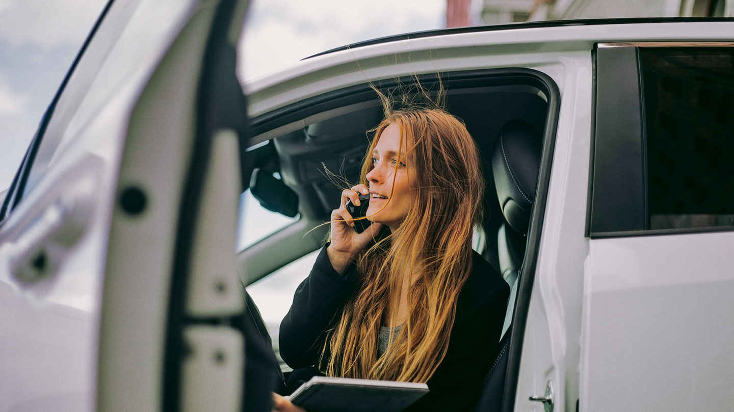 Woman on phone sitting in car