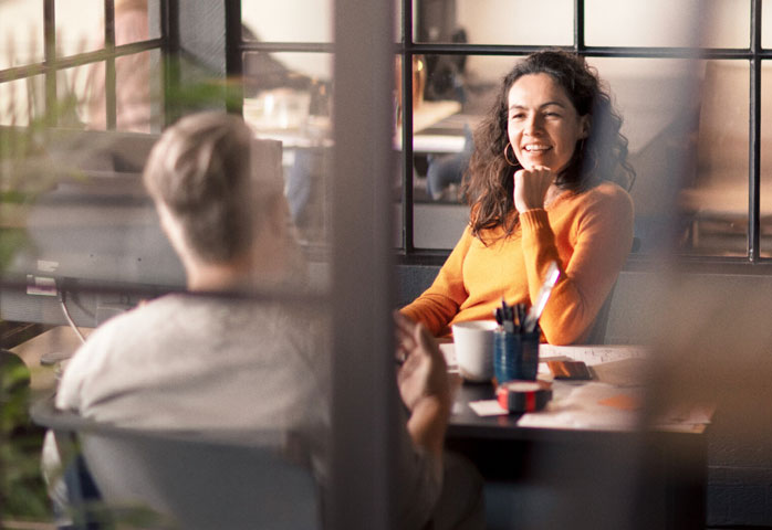 Woman in orange top in a meeting room