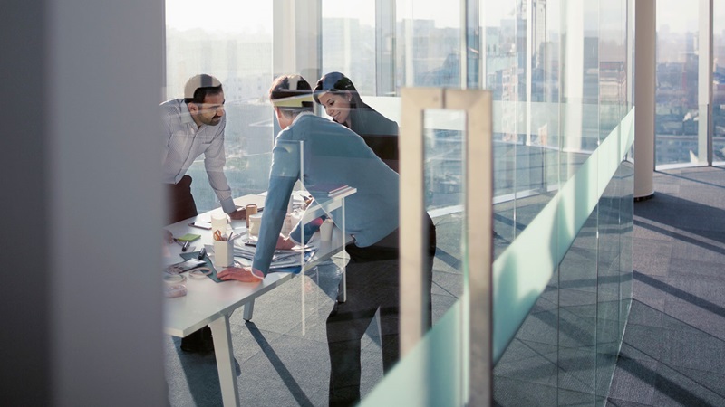male and female colleagues in glass office male and female colleagues in glass office