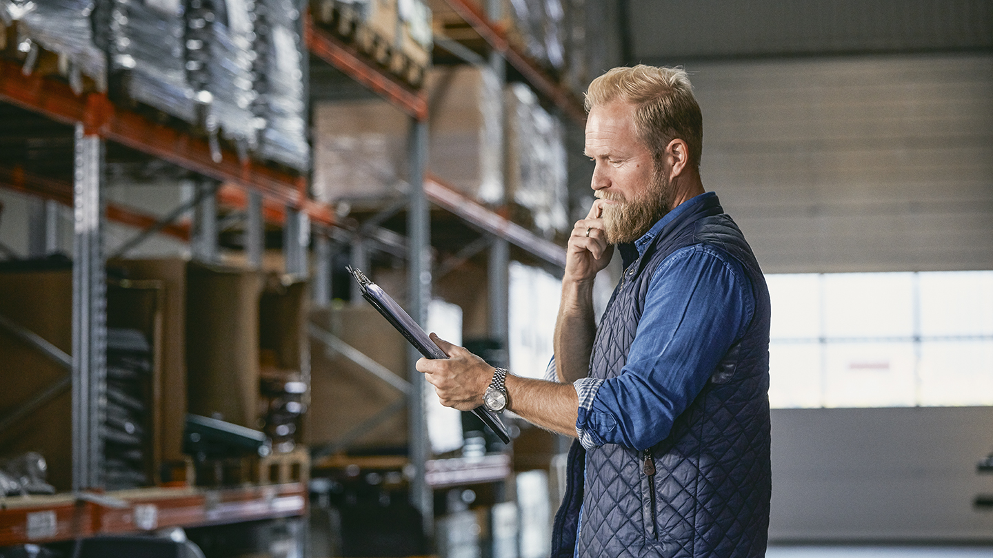 Man in a warehouse with clipboard