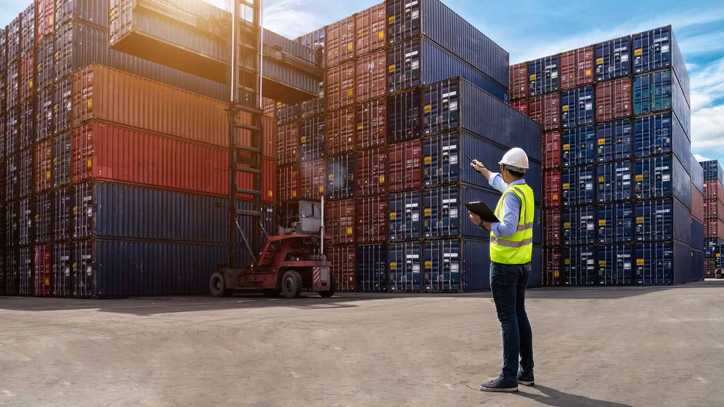 Man in Hi Vis vest pointing to forklist