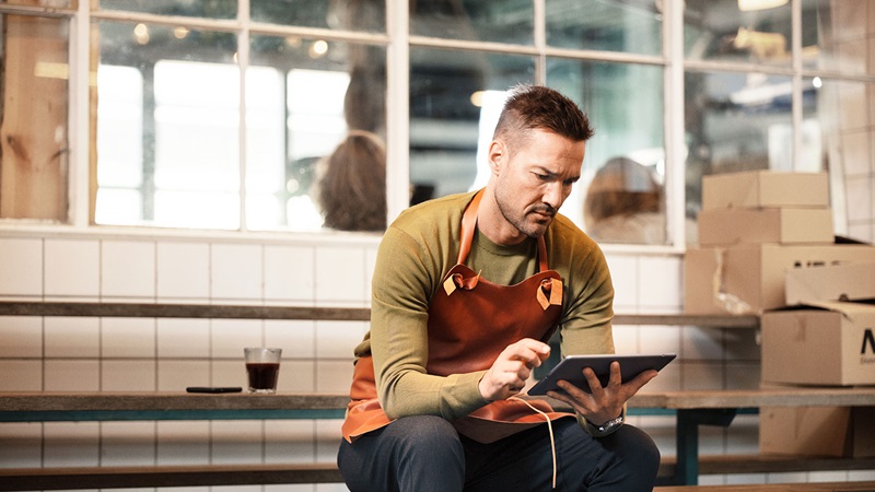 Male using tablet device Male using tablet device