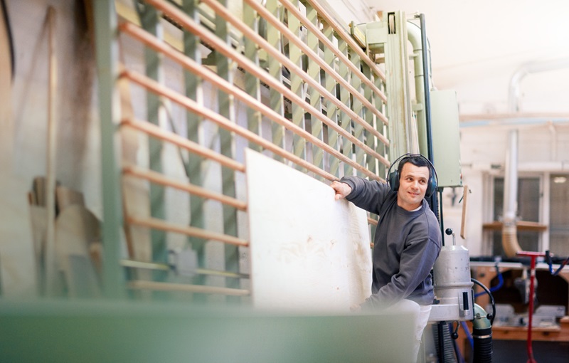 Man in workshop wearing ear defenders