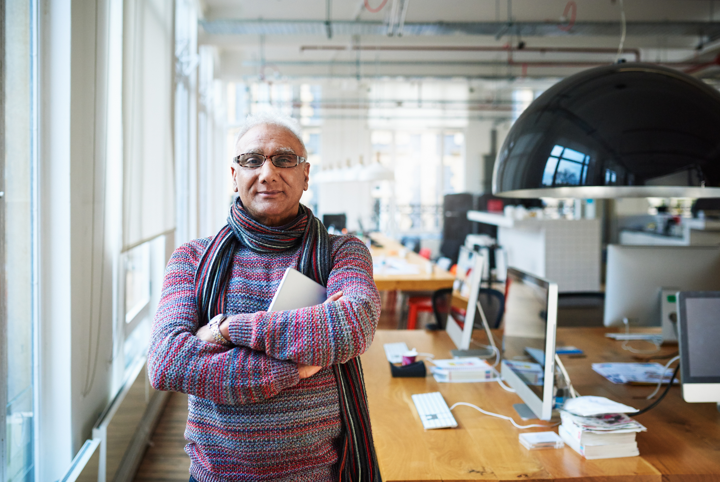 Older gentleman posing in office