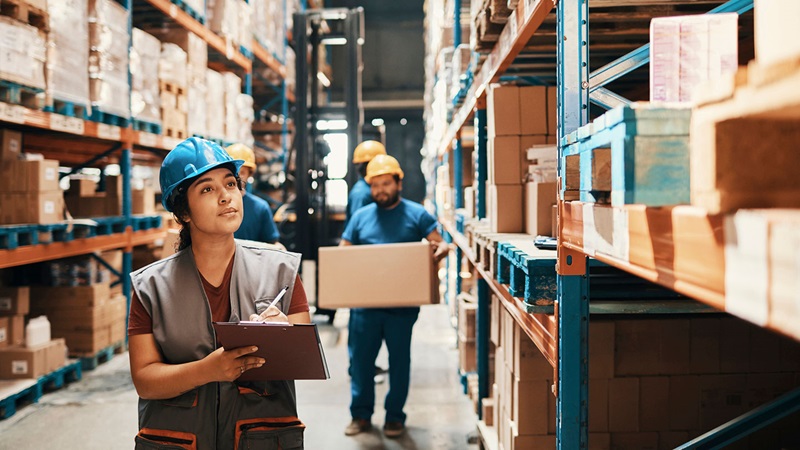 Warehouse workers checking stock and moving packages Warehouse workers checking stock and moving packages