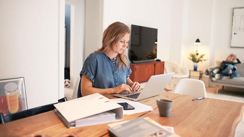 Woman at dining table on laptop Woman at dining table on laptop
