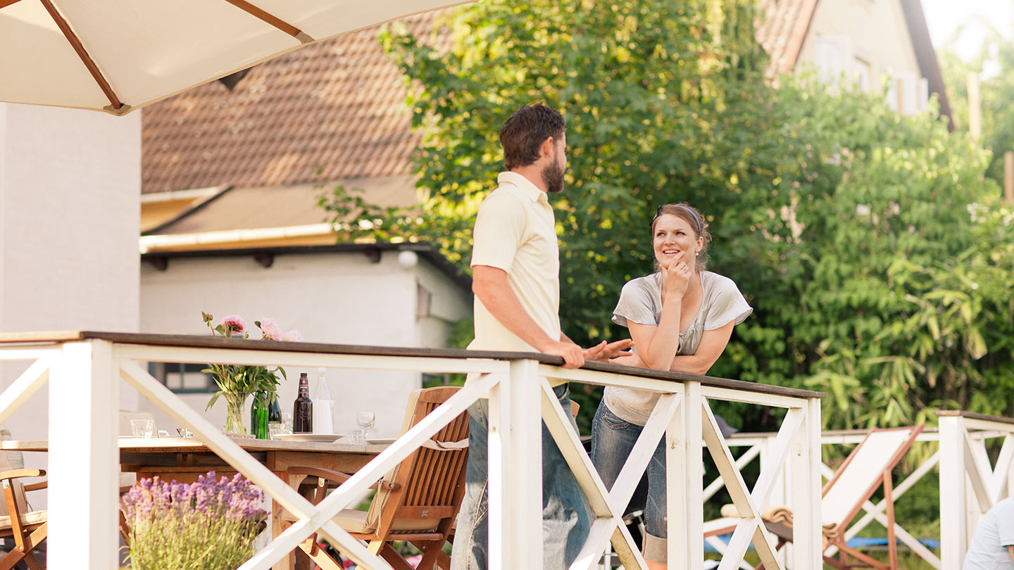 Man and woman talking in back garden