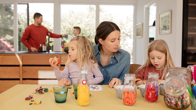 Mother and father in kitchen with their children