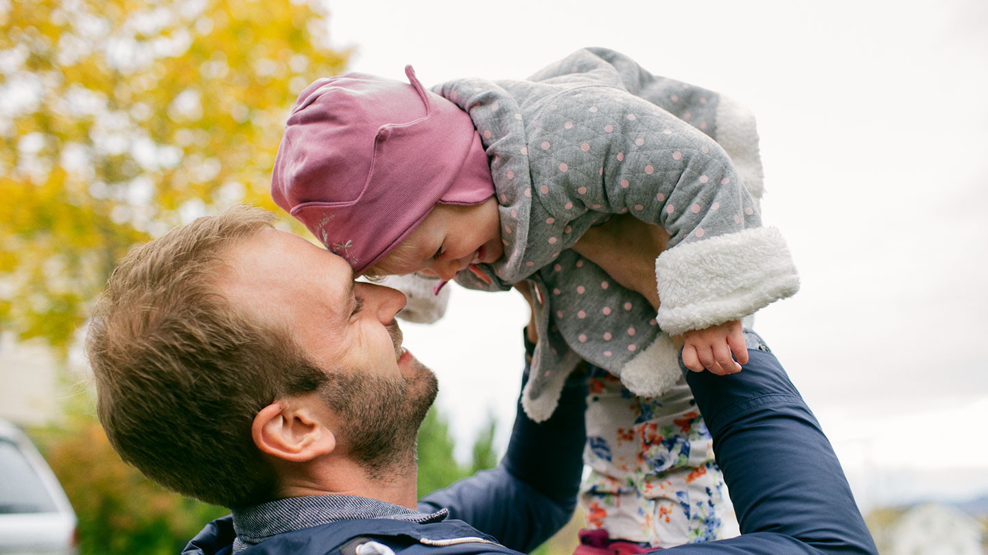 Man holding child in the air
