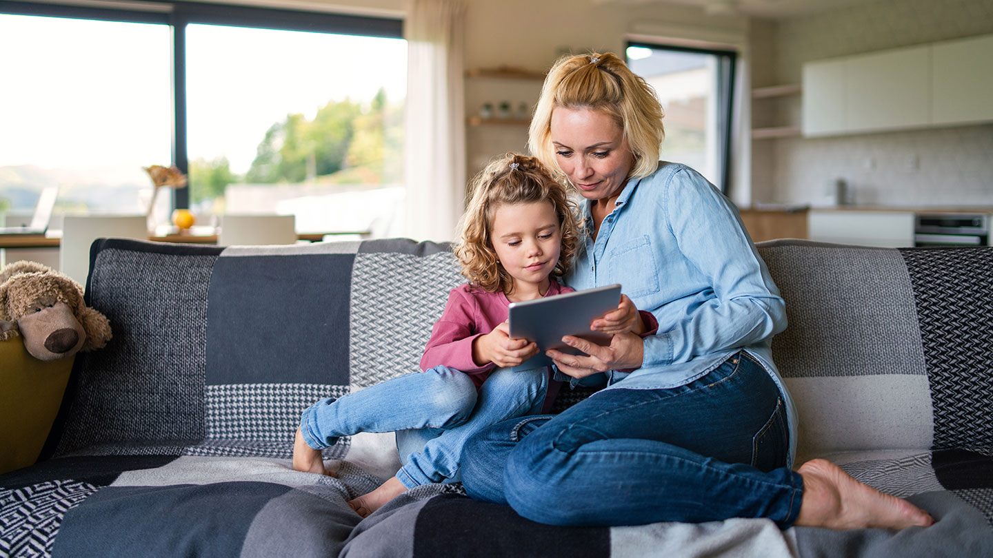 Mother and daughter sharing iPad