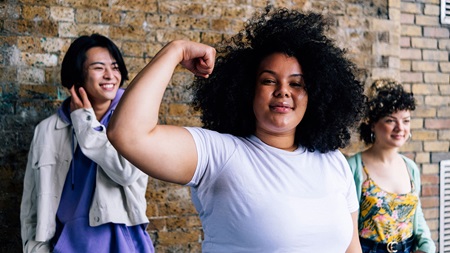 Teenage girl flexing bicep Teenage girl flexing bicep