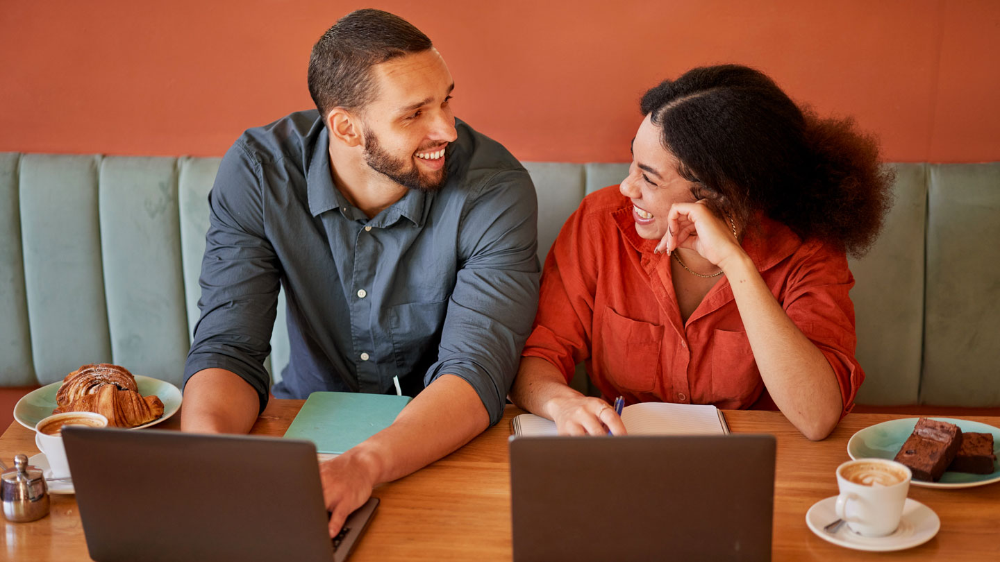 happy-couple-with-coffee-and-tablet-devices