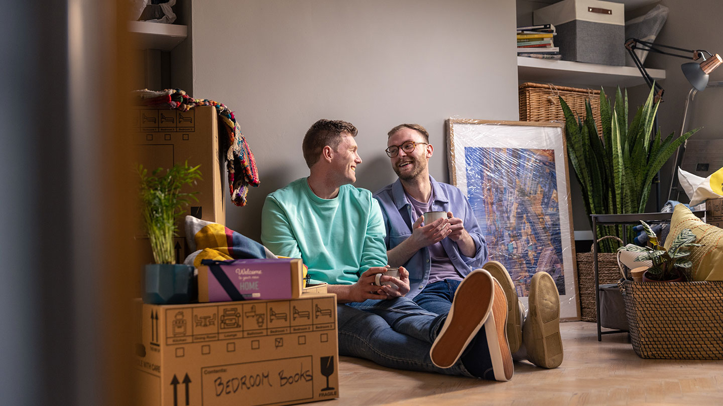Male couple smiling at eachother
