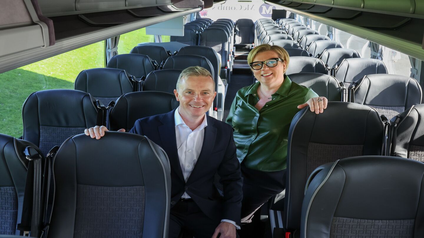 Greame Spratt and Caroline McComb pictured sitting inside a McComb's coach