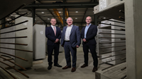 Moore Concrete invests 3m in 3 new factories with Danske support Three men stand inside a concrete manufacturer factory.