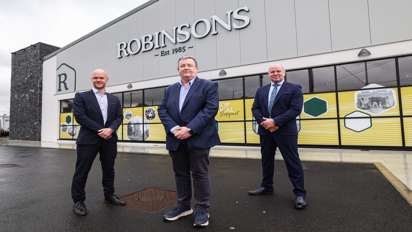 Three men stand outside the newly extended Robinsons shop in Ballymena.