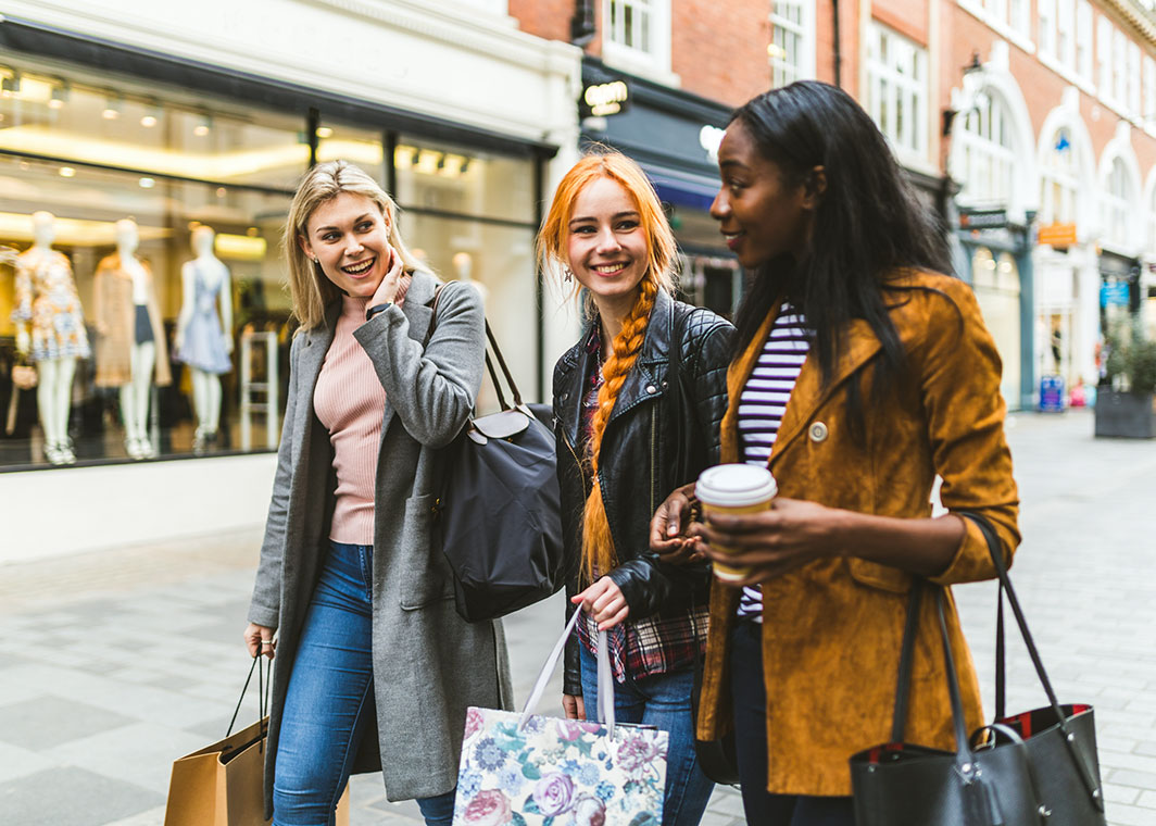 Ladies shopping together, chatting and smiling