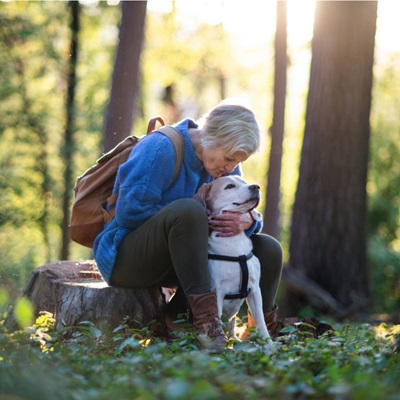Woman in woods with dog