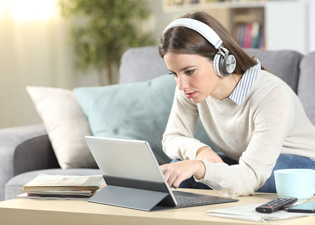 Young woman reading on tablet device
